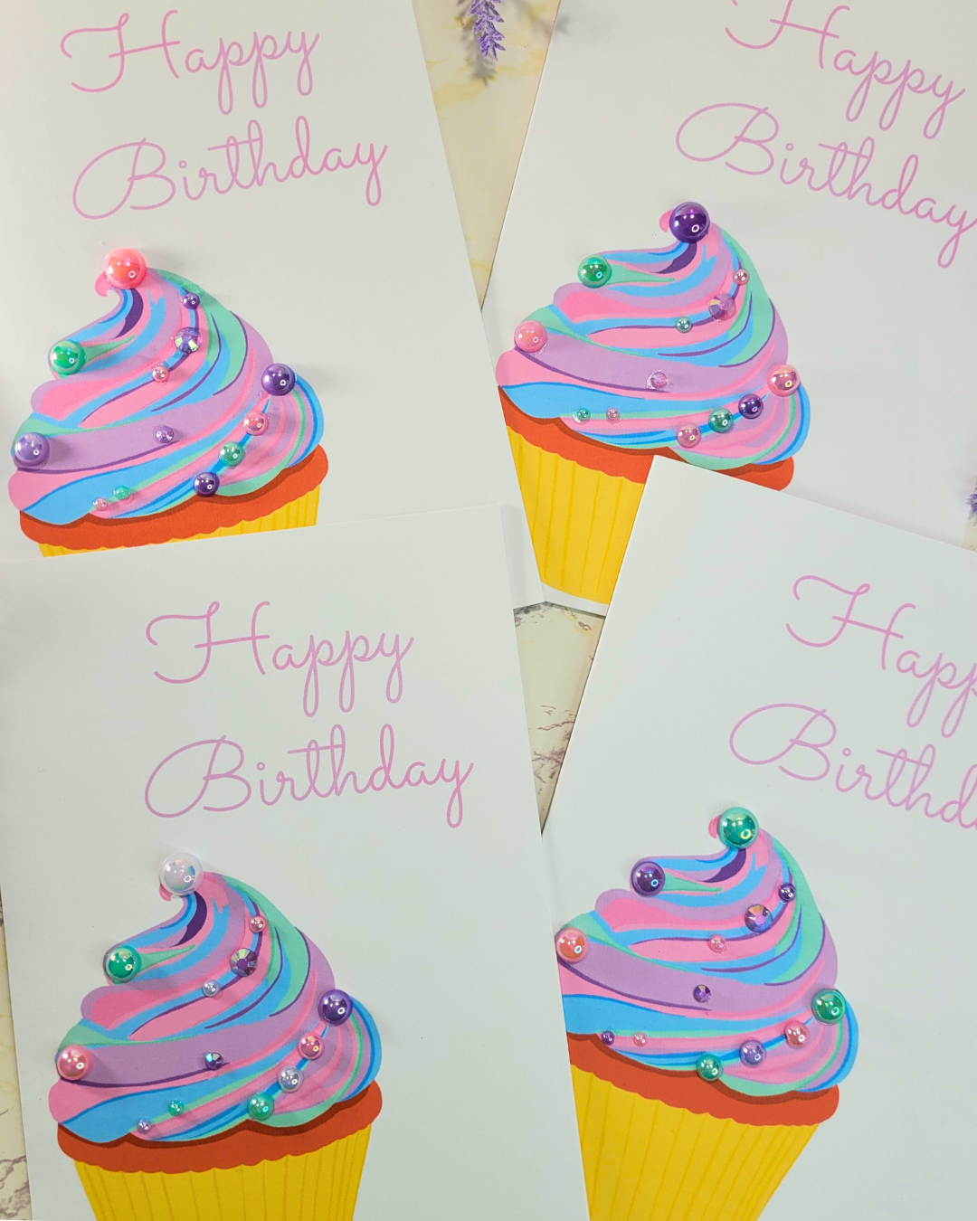 Four Happy Birthday cards featuring a cupcake. Each card has flat back pearls on the cupcake. 